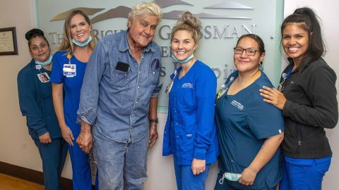 Jay Leno (center) is pictured with staff at The Grossman Burn Center on November 21 in Los Angeles.